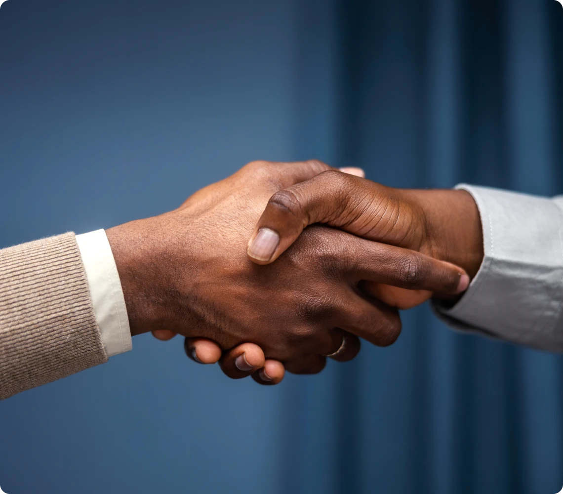 Professional handshake on blue background